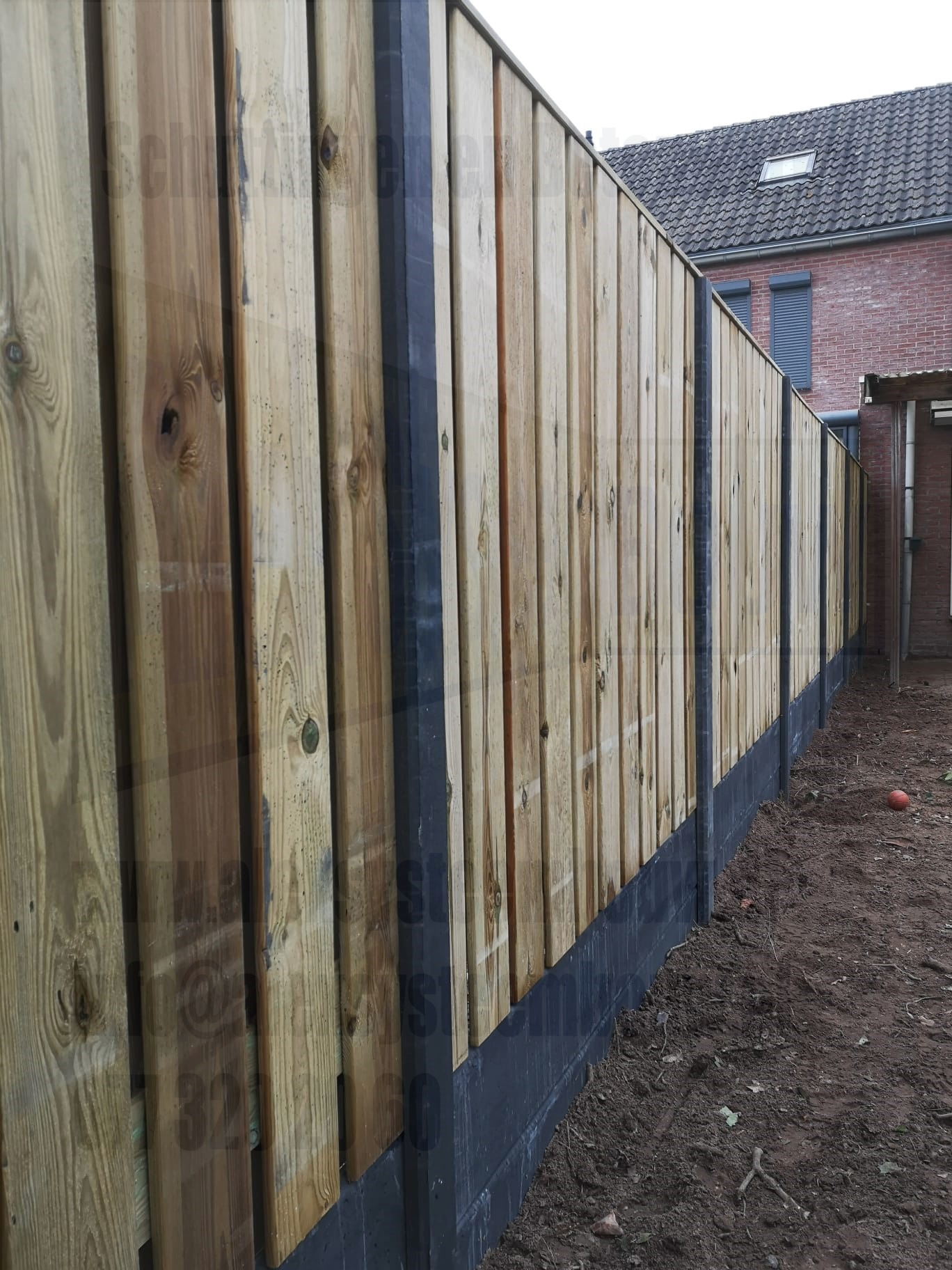 23 planks geïmpregneerde grenen tuinschermen i.c.m. 2 betonnen onderplaten per vak